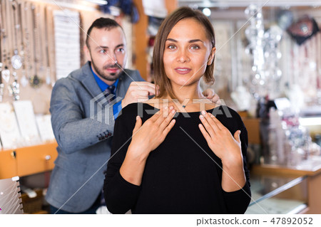 man helps to trying chainlet and pendants man helps to trying chainlet and pendants 47892052