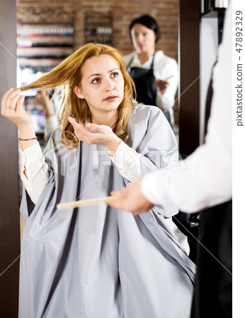 Young woman is not happy with her hair Young woman is not happy with her hair 47892329