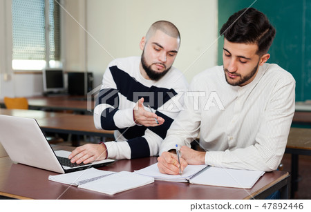 Students preparing for exams in classroom Students preparing for exams in classroom 47892446