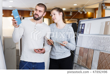Glad couple looking sample of ceramic tile 47892496