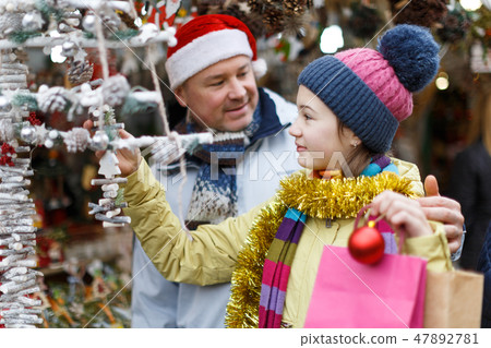 Girl selecting Christmas decoration Girl selecting Christmas decoration 47892781