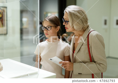 Woman and girl visiting museum 47892793