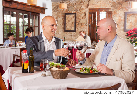 Two handsome men at restaurant 47892827