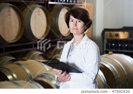 Expert examines equipment at winery Expert examines equipment at winery 47892830