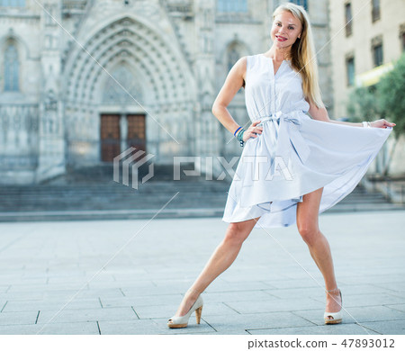 Glad female moving at the street in summer Glad female moving at the street in summer 47893012