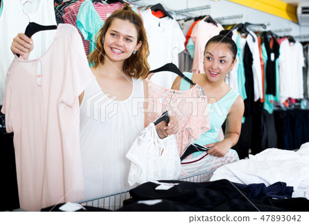 Young women shopping at the clothing store Young women shopping at the clothing store 47893042