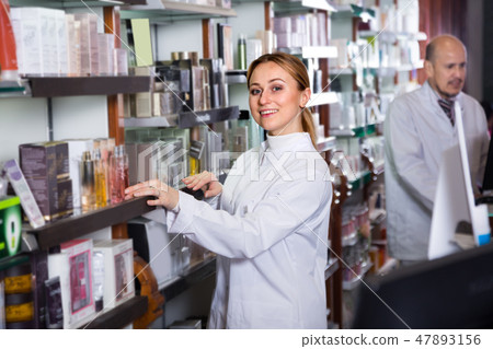 pharmacists standing with a cash desk 47893156