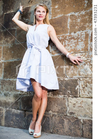 female standing near the stone wall 47893231