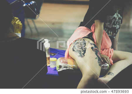 Tattoo artist drawing art on body 47893693