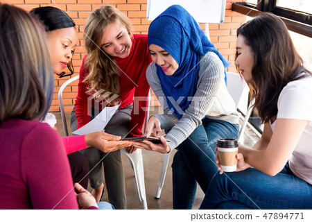 Group of multi-ethnic women in a project meeting  47894771