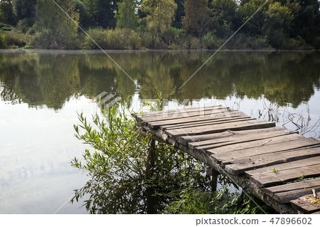Old ruined pier on the river on a foggy morning. 47896602