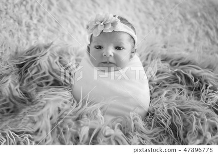 the face of a child with a bandage with flowers on his head close-up the face of a child with a bandage with flowers on his head close-up 47896778