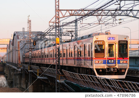 Keisei railway crossing the iron bridge in the setting sun (Model 3500) Keisei railway crossing the iron bridge in the setting sun (Model 3500) 47896786