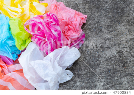 Colorful disposable plastic bags on cement Colorful disposable plastic bags on cement 47900884