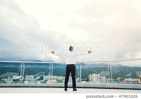 Businessman standing keeping arms raised Businessman standing keeping arms raised 47901826
