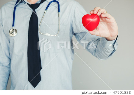 Doctor holding heart on background of Hospital Doctor holding heart on background of Hospital 47901828