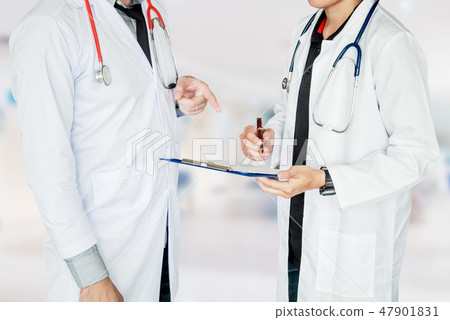 Two Doctor is talking about work in the hospital. 47901831