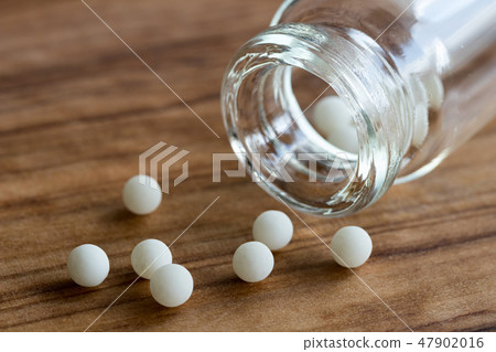 Homeopathic globules and a bottle Homeopathic globules and a bottle 47902016