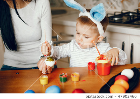 Mother with little son in a kitchen Mother with little son in a kitchen 47902466