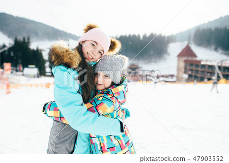 Smiling children enjoying winter vacations in mountains . Ski, Sun, Snow and fun 47903552