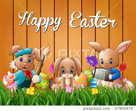 Happy easter bunnies on a background fence Happy easter bunnies on a background fence 47904478