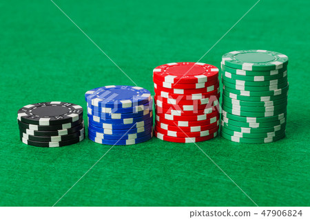 Casino chips on green table Casino chips on green table 47906824