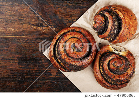 rolls with poppy seeds on a plain napkin rolls with poppy seeds on a plain napkin 47906863