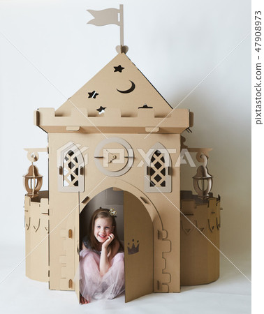 Beautiful little girl in princess dress playing with her toy castle. Beautiful little girl in princess dress playing with her toy castle. 47908973