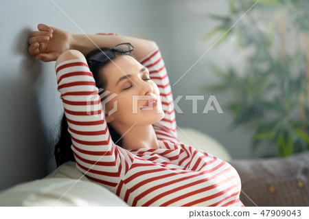 woman resting on sofa woman resting on sofa 47909043