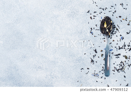 Variety of dry tea leaves and flowers in spoons  47909312