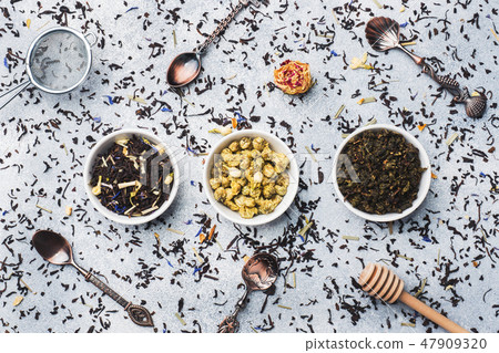 Variety of dry tea leaves and flowers in bowl  47909320