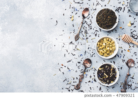 Variety of dry tea leaves and flowers in bowl Variety of dry tea leaves and flowers in bowl 47909321