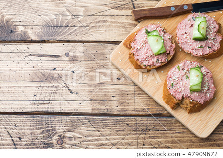 Sandwiches with chicken pate and cucumber  47909672