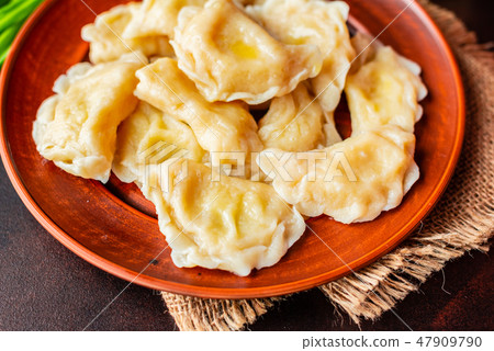 The boiled made dumplings with a stuffing  47909790