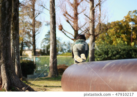 A boy playing in a park 47910217