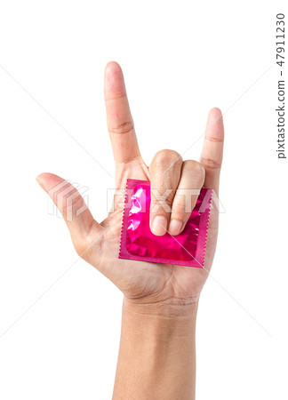Pink condom in pack on hand showing love symbol. Pink condom in pack on hand showing love symbol. 47911230