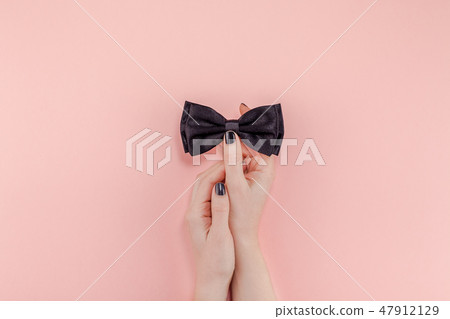 Black bow tie woman hand for men fathers concept 47912129