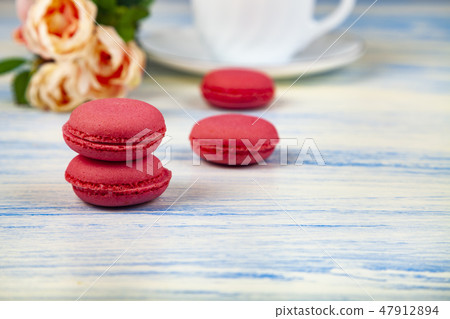 Berry macaroons. white cup and rose Berry macaroons. white cup and rose 47912894