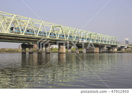 Keihin Tohoku Line E233 train crossing the Arakawa bridge 47912950