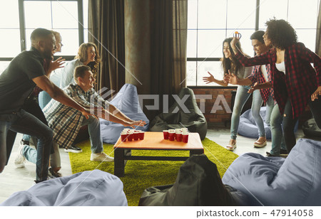 Students party with beer pong game Students party with beer pong game 47914058