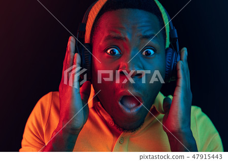 The young handsome hipster man listening music with headphones The young handsome hipster man listening music with headphones 47915443