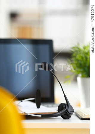 Empty remote office workplace with laptop and headset 47915573