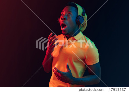 The young handsome hipster man listening music with headphones The young handsome hipster man listening music with headphones 47915587