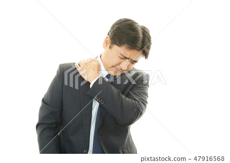 A man suffering from stiff shoulders 47916568