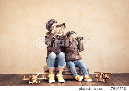 Happy children playing with toy airplane 47916738