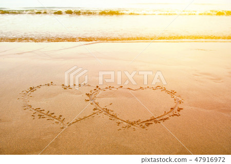 love by Hand write heart on sand at beach love by Hand write heart on sand at beach 47916972