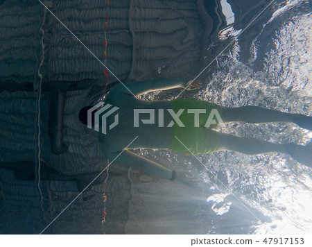 people swimming in pool view from the underwater 47917153