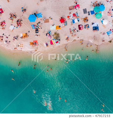 aerial view of sunny sandy beach with blue azure water 47917233