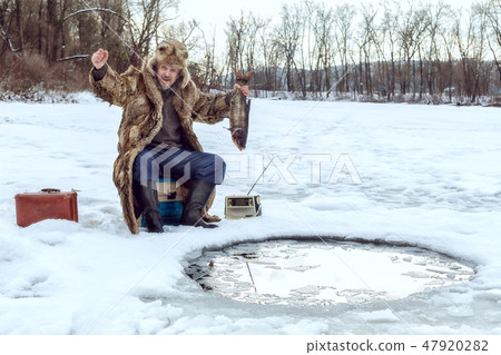 Elderly man on winter fishing. Elderly man on winter fishing. 47920282