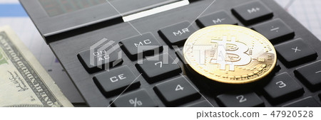 The bitcoin lies on the keyboard of the black The bitcoin lies on the keyboard of the black 47920528